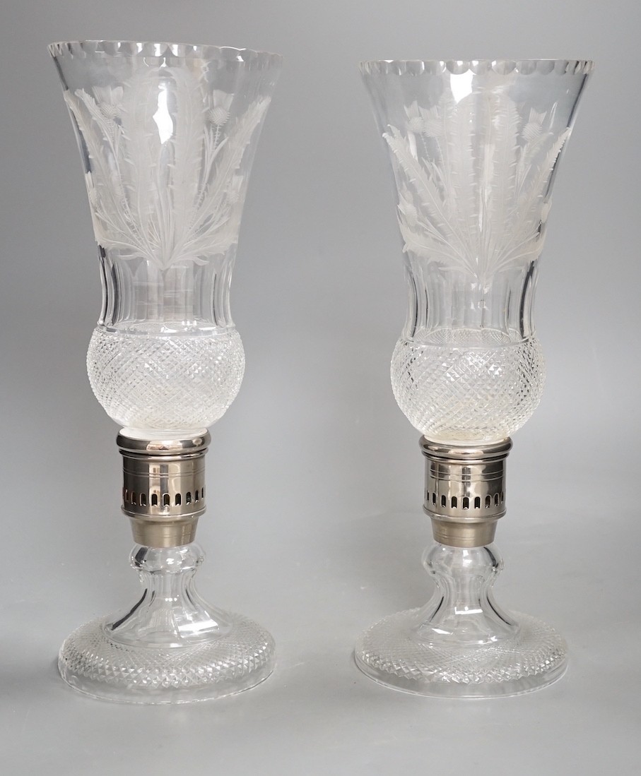 A pair of thistle engraved and cut glass storm lamps - 35cm tall